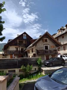 a house with a car parked in front of it at Gîte à Molines en Queyras 8-15 pers in Molines-en-Queyras