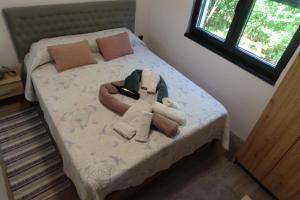 a bed with a robe and towels on it at Villa Petrovic in Fažana +37 photos