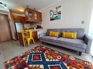 a living room with a couch and a kitchen at Departamentos Concepcion Centro in Concepción +55 photos