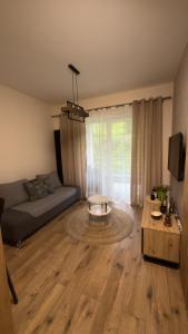 a living room with a couch and a coffee table at Apartament Tatarska 4B in Przemyśl