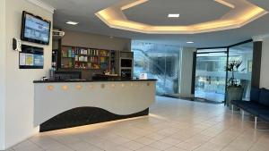 a lobby with a bar in a building at Nautillus Hotel in Parnaíba