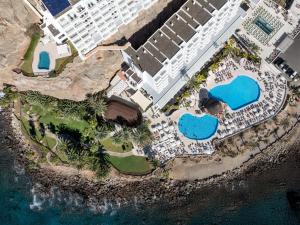 an aerial view of a resort with two swimming pools at Princess Taurito in Taurito