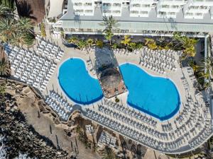 an overhead view of a resort with two swimming pools at Princess Taurito in Taurito