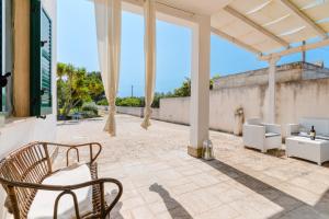 a patio with two chairs and a table at Casa Vacanza Plautilla - Salento Selection in Maglie