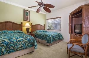 a bedroom with two beds and a ceiling fan at Wyndham Bali Hai 2BR Villa with Resort Access in Princeville +37 photos
