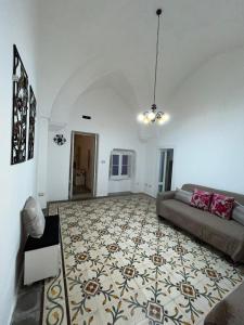 a living room with a couch and a rug at Gioem in Botrugno +15 photos