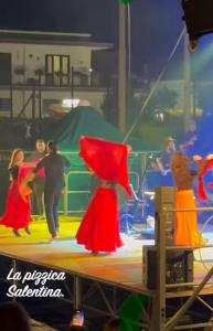a group of people dancing on a stage at Gioem in Botrugno