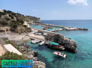 a group of boats in the water next to a pier at Gioem in Botrugno