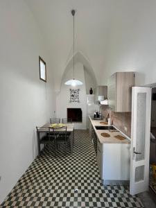a kitchen with a black and white checkered floor at Gioem in Botrugno