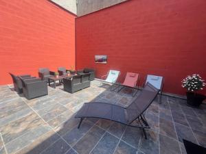 a room with tables and chairs and a red wall at Hortense in Étaples