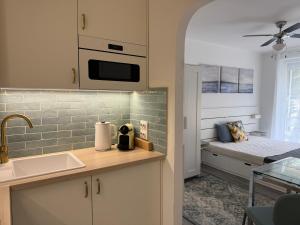a kitchen with a sink and a counter top at Blue Horizon Apartment in Balatonfüred