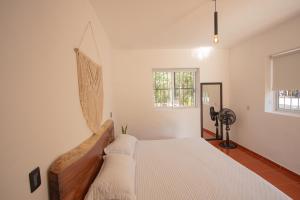 a bedroom with a large bed in a room at Cenote Popol Vuh in Leona Vicario