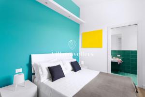 a bedroom with a white bed and a blue wall at Casale degli Erei in San Michele di Ganzaria +38 photos