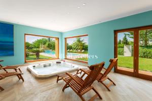 a living room with a tub and two chairs at Casale degli Erei in San Michele di Ganzaria