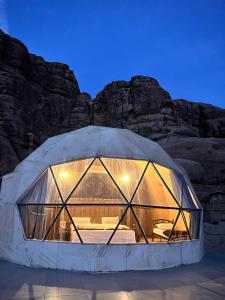 a dome tent with a bed inside of it at Layla Wadi Rum in Disah