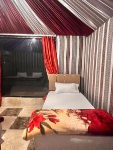 a bedroom with a bed in a tent at Layla Wadi Rum in Disah