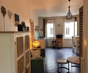 a living room with a couch and a table at Cabine de la plage 2 in Fécamp
