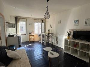 a living room with a couch and a table at Cabine de la plage 2 in Fécamp