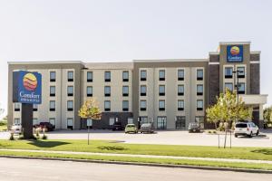 a large white building with a parking lot at Comfort Inn & Suites Avera Southwest in Sioux Falls