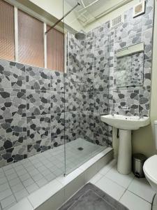 a bathroom with a shower and a sink and a toilet at Accommodation Front - Edgy Beachfront 2 Sleeper with Stunning View in Durban
