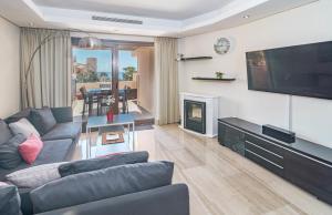 a living room with a couch and a television at BP7C.2A Beachfront Penthouse with Private Pool in Estepona