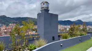 a lighthouse on the roof of a building at Wynwood House Stylish Loft in El Polo Modern & Central Stay in Bogotá