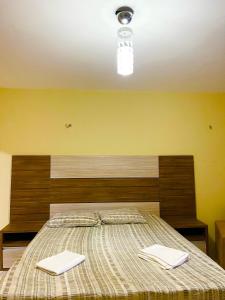 a bedroom with a bed with two towels on it at Casa Atalaia Paraíso in Atalaia +58 photos