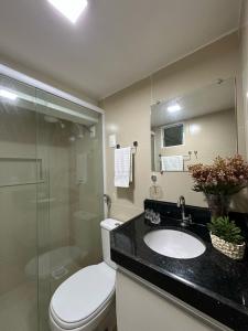 a bathroom with a toilet and a sink and a shower at Benfica Apart Hotel in Fortaleza +14 photos