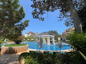 a swimming pool with umbrellas in a resort at Poseidon Nessebar Private Apartment in Nesebar +25 photos
