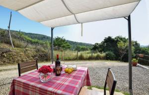 a table with a bottle of wine and fruit on it at 1 Bedroom Stunning Home In Subbiano in Subbiano