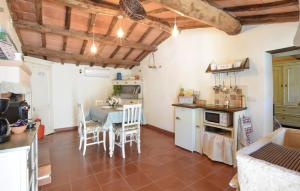 a kitchen with a table and chairs in a room at 1 Bedroom Stunning Home In Subbiano in Subbiano