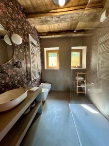 a bathroom with two sinks and a tub and a bath tub at Casa LoVi in Borgosesia +76 photos