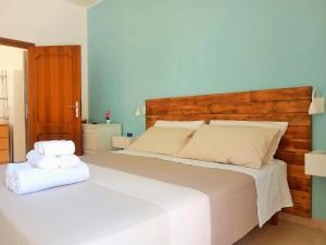 a bedroom with a large bed with two towels on it at Casa Galilei 5 minuti dal mare in San Salvo +7 photos