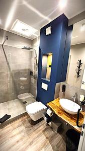 a bathroom with a toilet and a sink and a shower at Liro Hotel Mönchengladbach in Mönchengladbach +67 photos