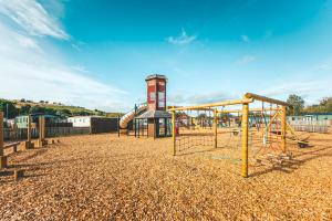 an empty playground with a slide and a play structure at Heather View Leisure Park - Ivy Caravan Pet 1 in Stanhope