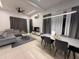 a living room with a couch and a table at Chen Villa Bukit Gambir 晨舍 in Bukit Gambir