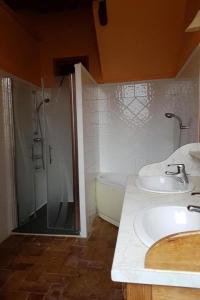 a bathroom with a shower and a sink and a tub at Le Clos des Buis 