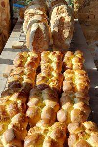 a bunch of loaves of bread on a cooling rack at Le Clos des Buis 