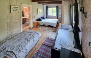 a bedroom with two beds and a living room at Gorgeous Home In Vinslöv With Wifi in Vinslöv