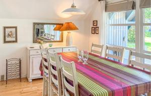 a dining room with a table and chairs and a mirror at 3 Bedroom Amazing Home In Højby in Højby