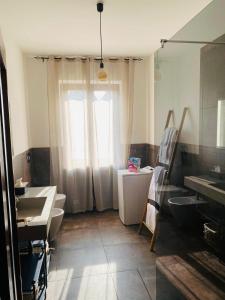 a bathroom with two sinks and two toilets and a window at Tenuta Oasi del cavallo in Sommacampagna +12 photos