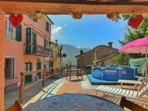 a view from the balcony of a house with a table at La casa con giardino, vicino al ruscello segreto in Borzonasca +7 photos