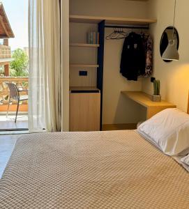 a bedroom with a bed and a view of a balcony at Yria Hotel in Zakynthos Town