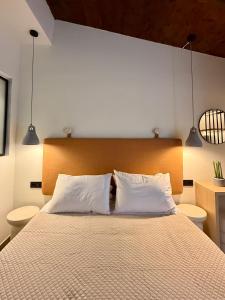 a bedroom with a large bed with two pillows at Yria Hotel in Zakynthos Town