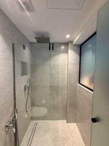 a bathroom with a shower with a glass door at Yria Hotel in Zakynthos Town