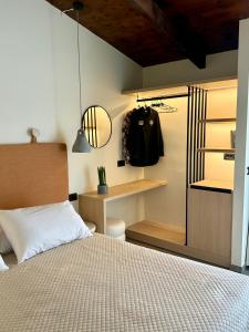 a bedroom with a bed and a desk and a closet at Yria Hotel in Zakynthos Town