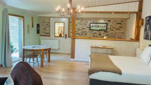 a bedroom with a bed and a table in a room at Domaine de Meros in Plonévez-du-Faou