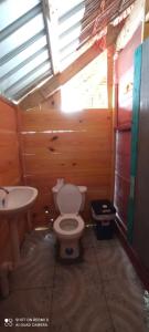 a bathroom with a toilet and a sink at Romantic Cabin on Diablo Island San Blas in Panama City