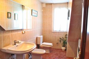 a bathroom with a sink and a toilet and a window at Casalvito in Rial +21 photos