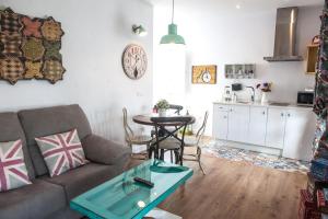 a living room with a couch and a table at Alhanía Vejer in Vejer de la Frontera